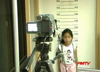 One young girl gets her picture taken for her 1st ID card.